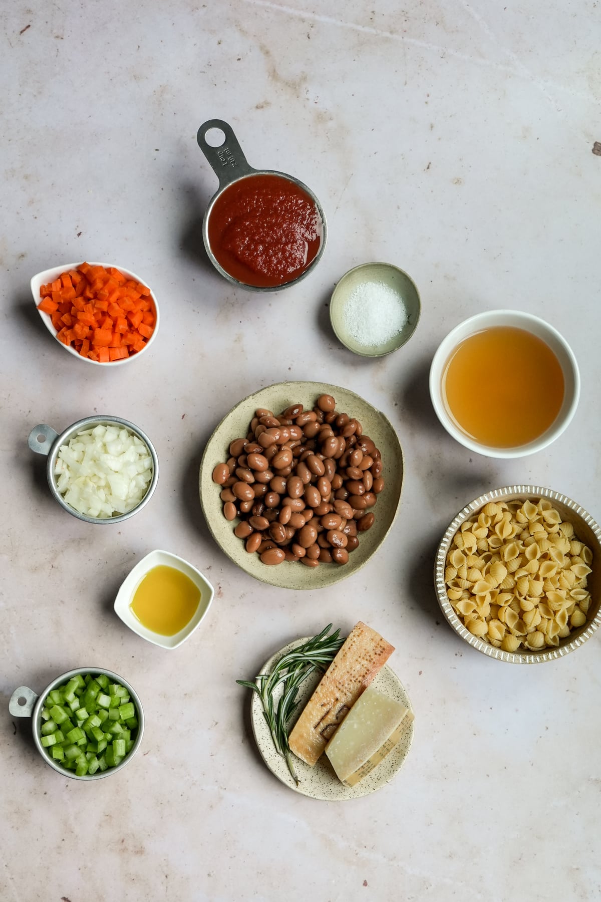 Ingredients for pasta fagioli - borlotti beans, celery, carrot. onion, passata, vegetable stock, pasta, rosemary, olive oil, salt