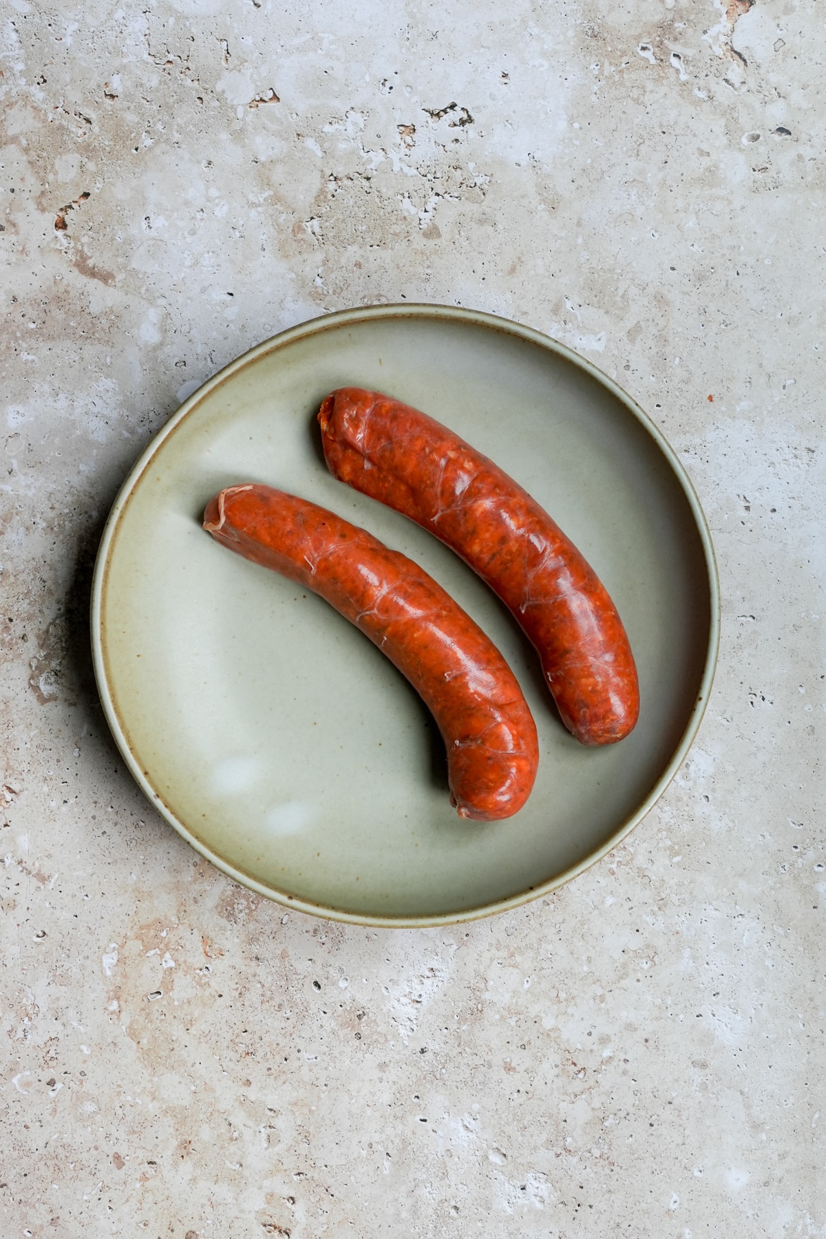 Two spicy sausages in a plate