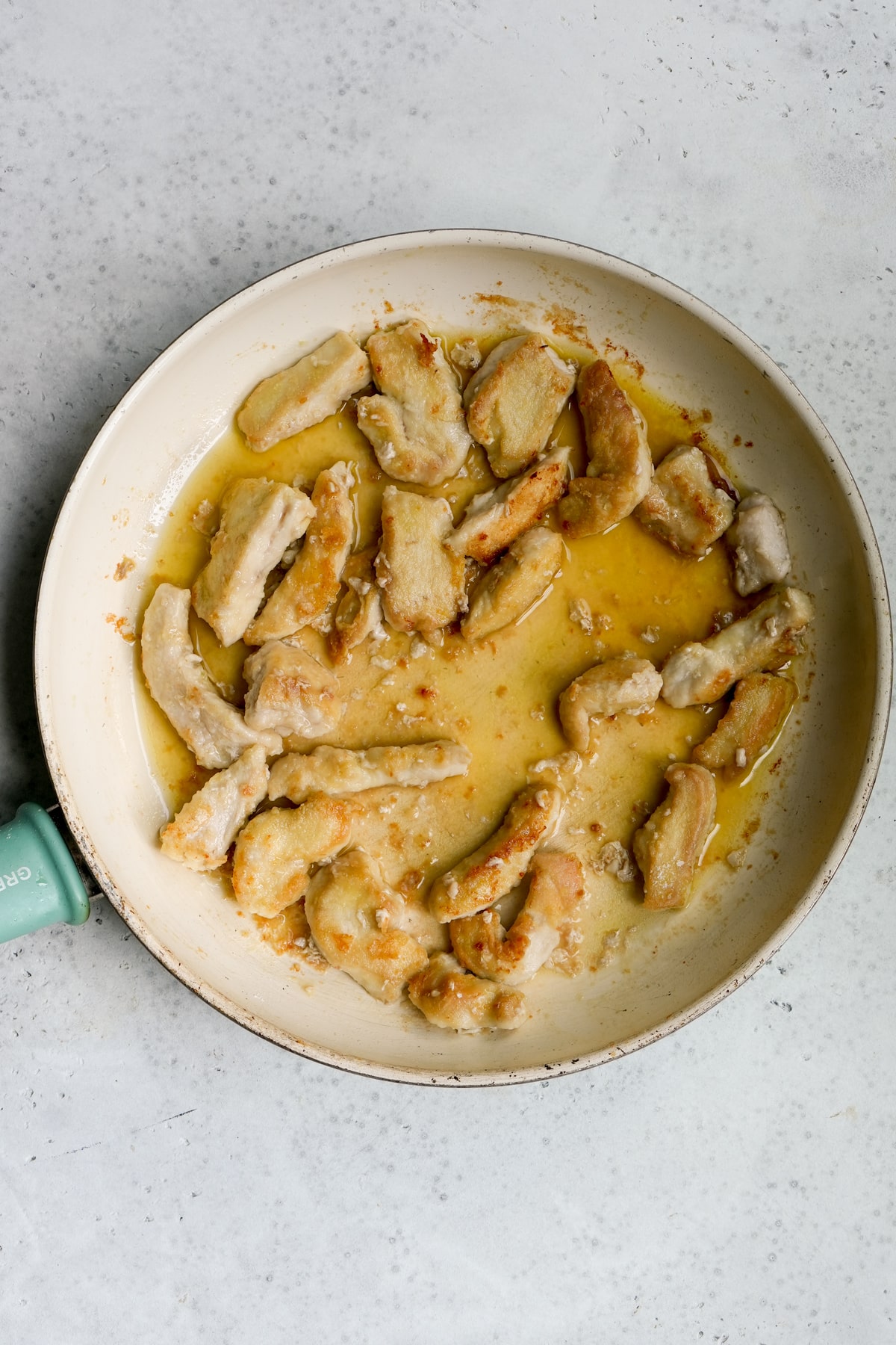 Process photo - chicken breast in a skillet with white wine