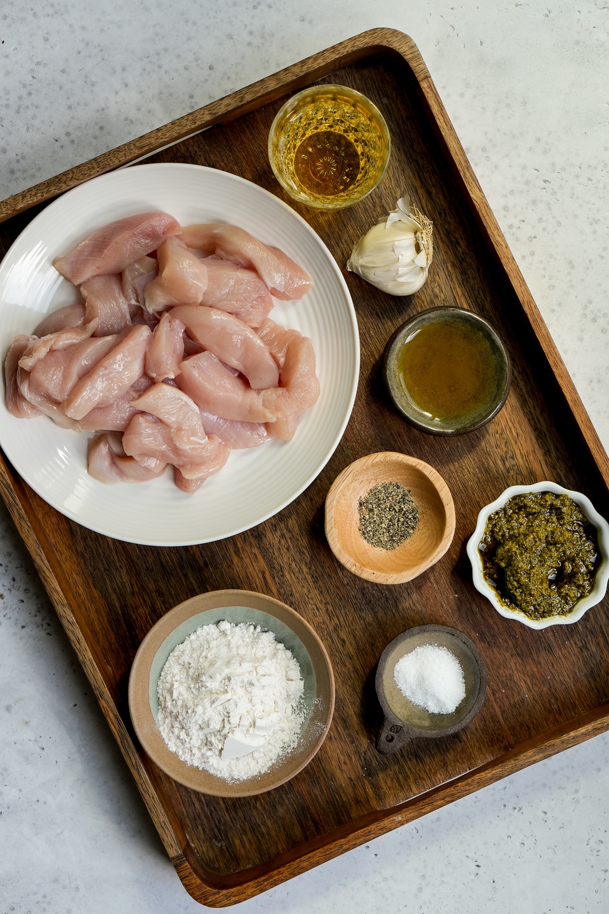 Pesto chicken ingredients - chicken strips, white wine, garlic, olive oil, salt, pepper, flour, pesto