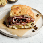 Salami sandwich with pecorino cream, artichoke spread, fennel salami and spicy eggplant