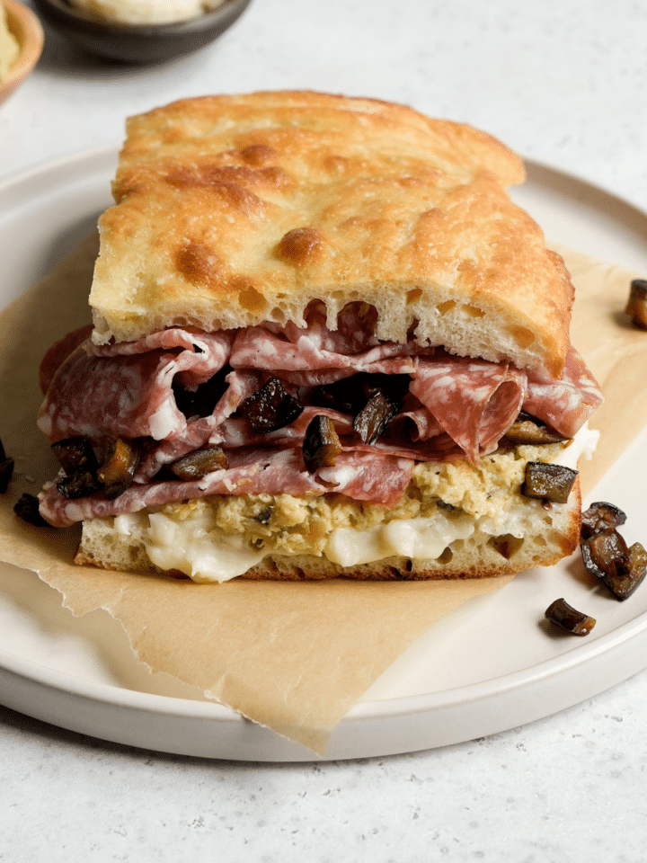 Salami sandwich with pecorino cream, artichoke spread, fennel salami and spicy eggplant
