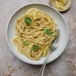 Lemon pesto pasta in a dish with a fork to the side