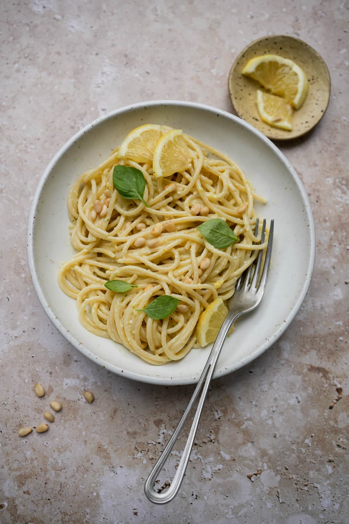 Lemon pesto pasta in a dish with a fork to the side