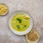 Lemon pesto in a bowl with a small dish of pine nuts to the side