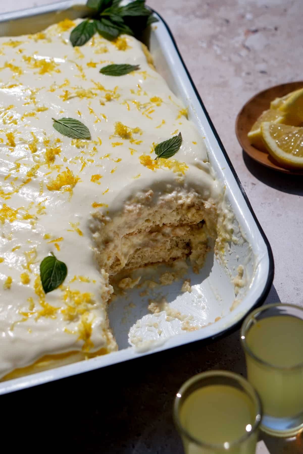 Limoncello tiramisu in a pan with a slice cut out
