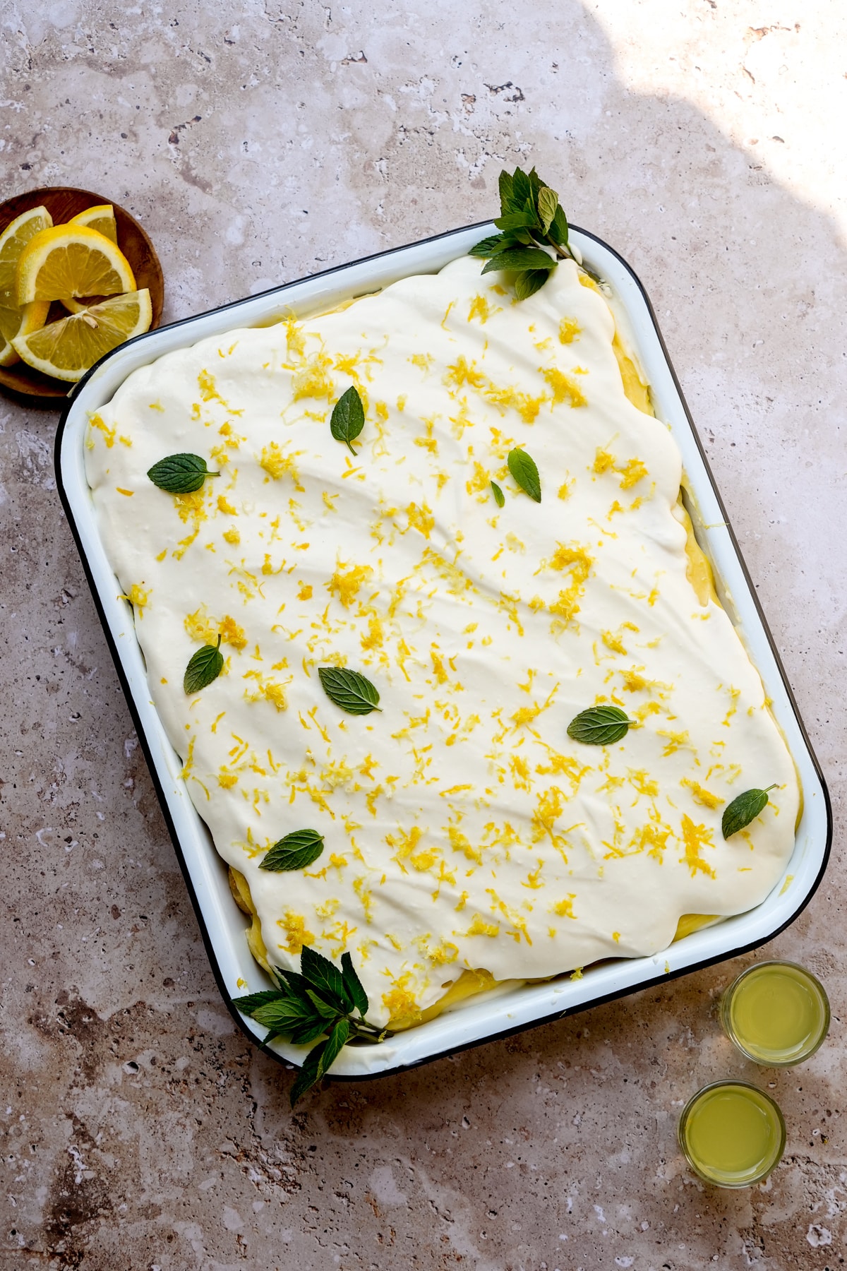Limoncello tiramisu in a pan topped with lemon zest