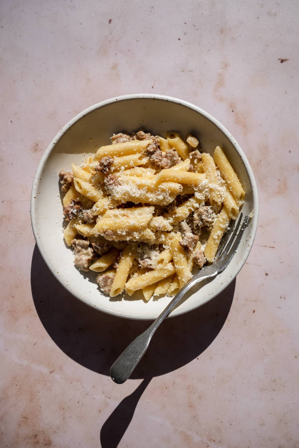 Pasta alla norcina in a bowl, topped with grated pecorino romano