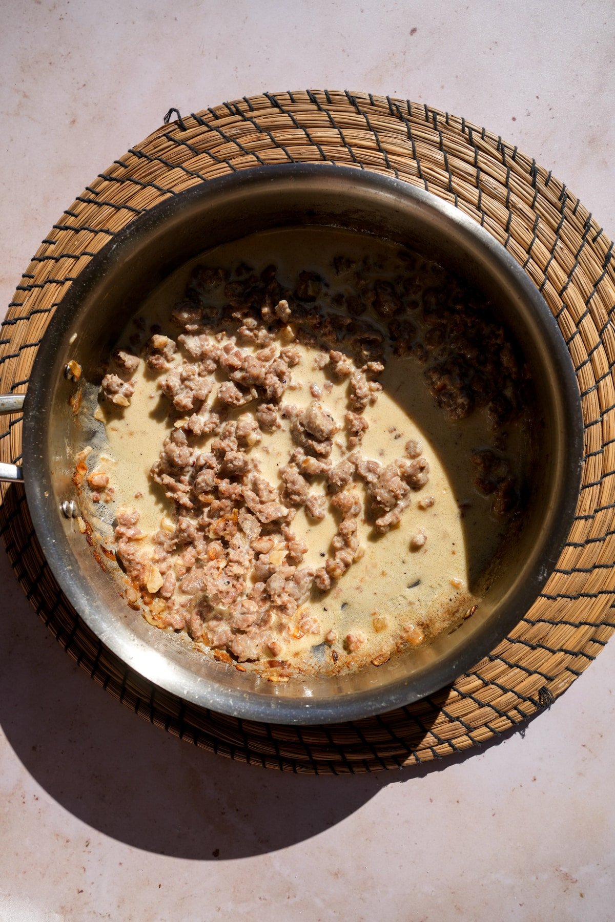 Cooked sausage and heavy cream in a pan (sauce for pasta alla norcina)