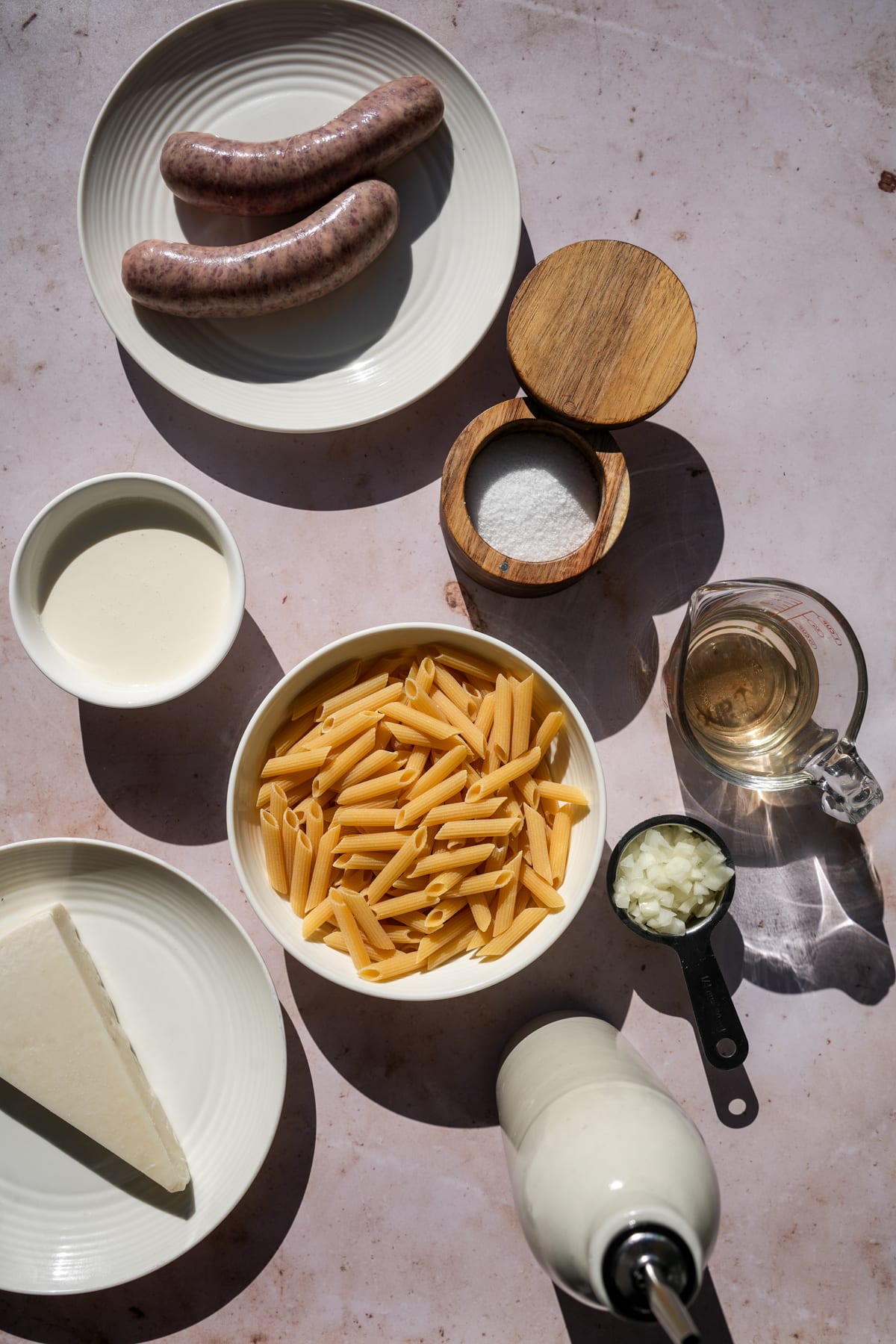 Pasta alla norcina ingredients - Italian sausage, salt, heavy cream, penne pasta, white wine, onions, olive oil. pecorino romano cheese