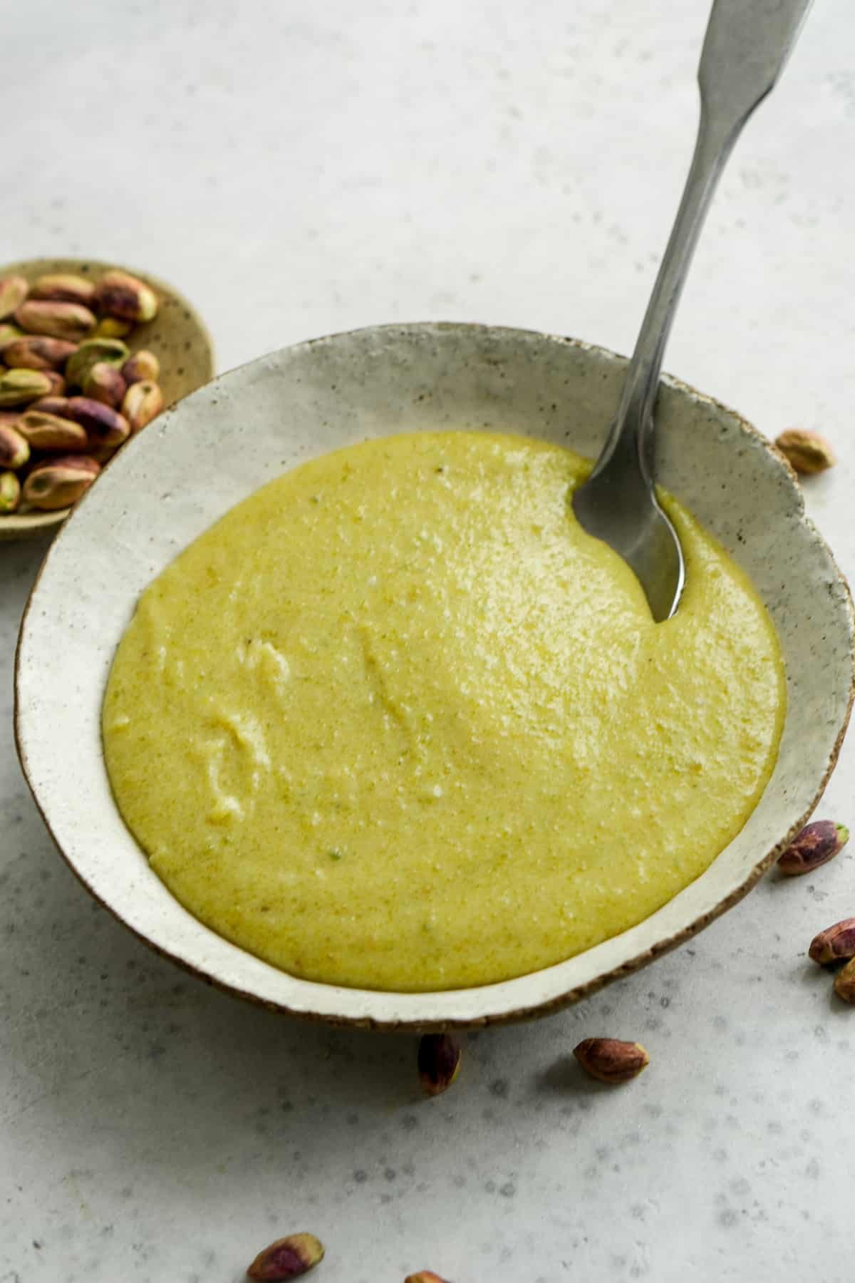 Pistachio cream in a bowl with a spoon