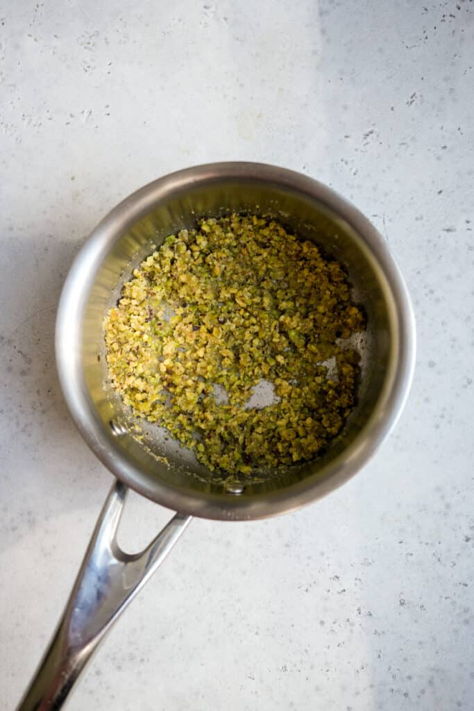 Pistachio crumble in a small saucepan