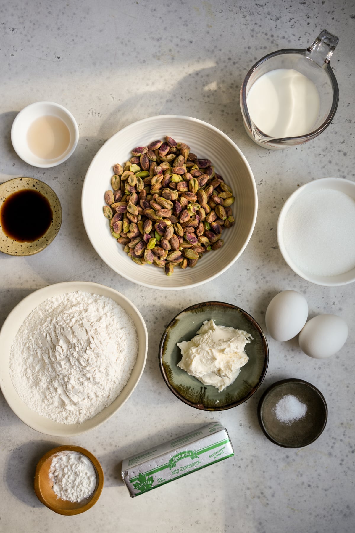 Pistachio muffin ingredients - raw shelled pistachios, milk, sugar, eggs, mascarpone, butter, salt, baking powder, flour, vanilla extract, almond extract