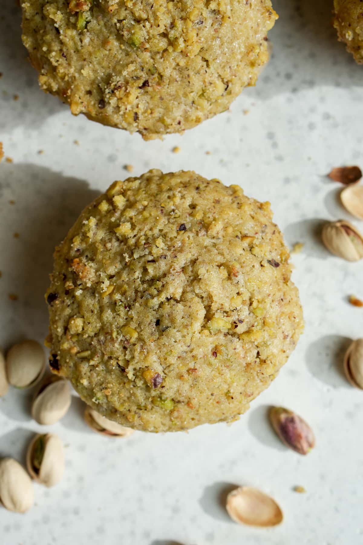 Pistachio muffin topped with a pistachio crumble
