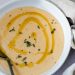 Italian white bean soup in a bowl topped with olive oil and rosemary