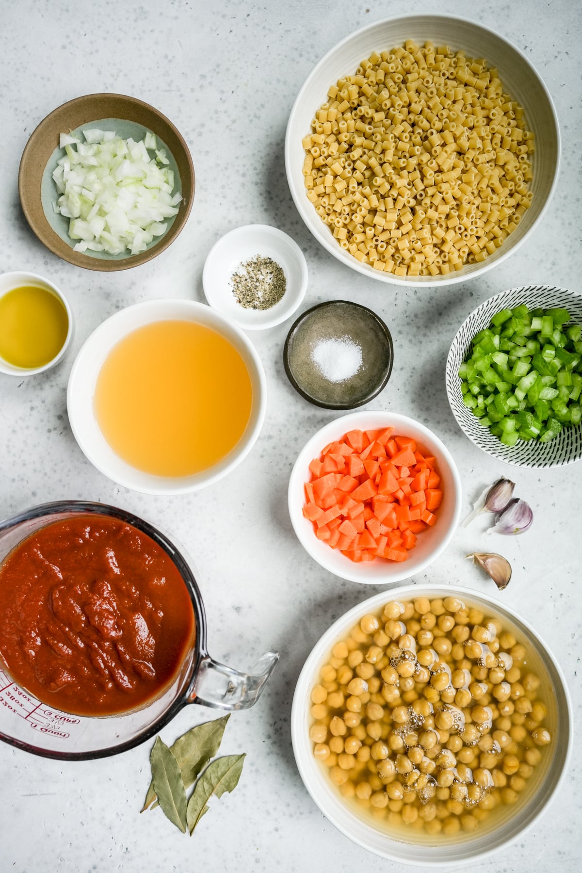 Pasta e ceci ingredients - Canned chick peas, small pasta (ditalini), carrot, celery, onion, salt, pepper, chicken broth, olive oil, tomato puree, bay leaves