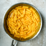 Penne in pumkin pasta sauce in a pan