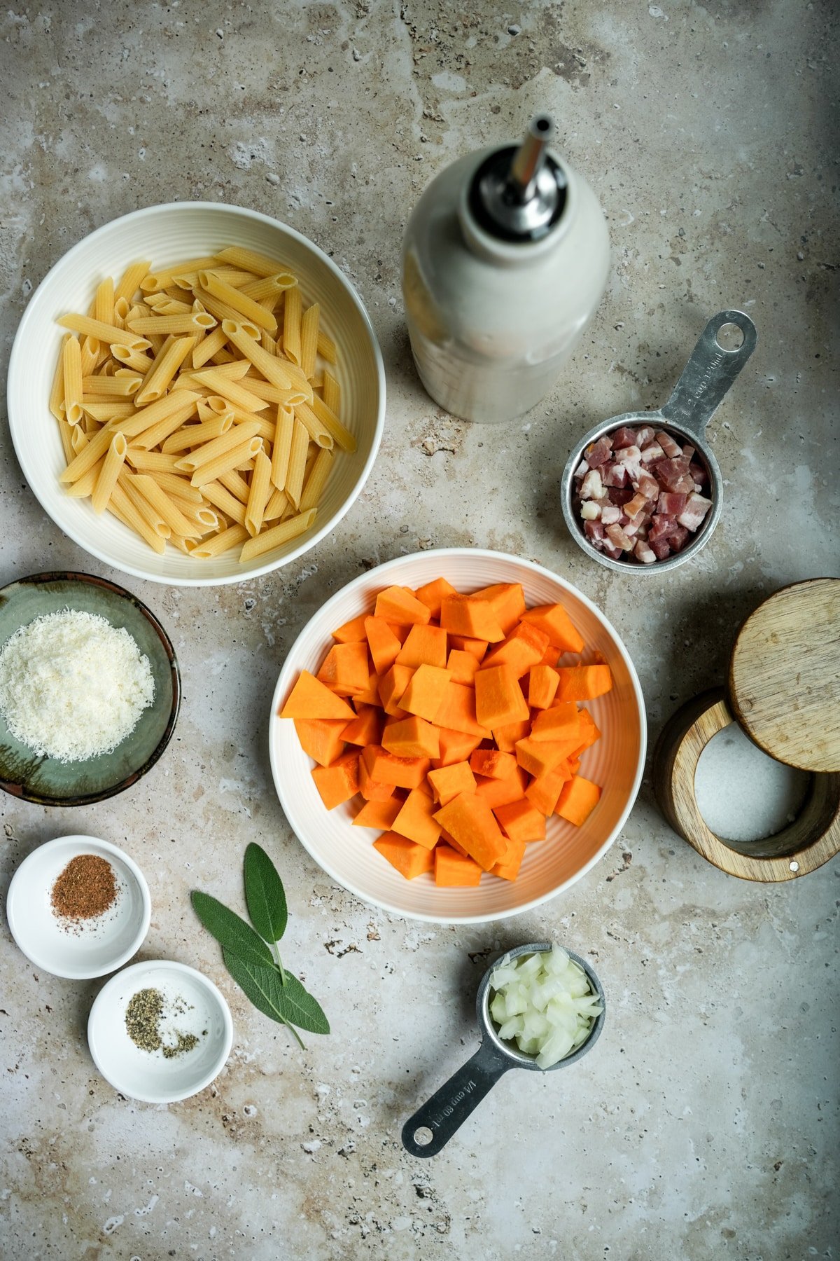 Pumpkin pasta sauce ingredients - olive oil, cubed pumpkin, diced pancetta, salt, onion, sage, pepper, nutmeg, grated parmigiano reggiano