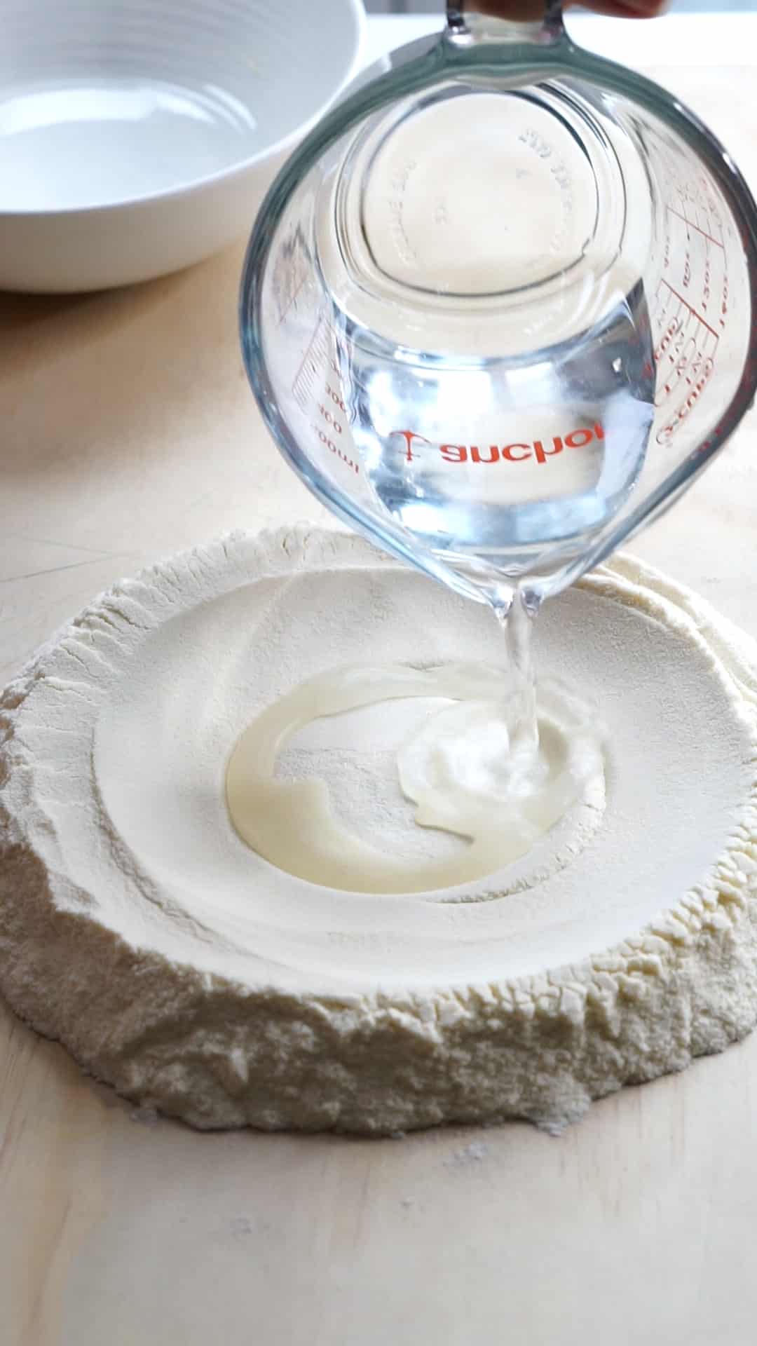 Well of semola rimacinata with water being poured in