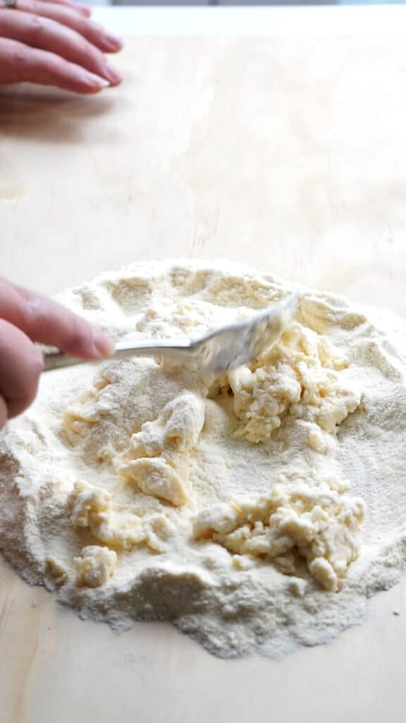 Semola rimacinata and water being mixed together with a fork