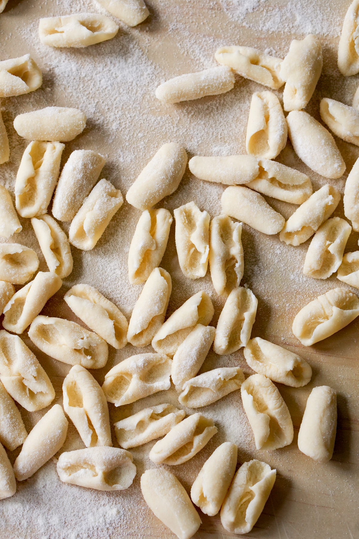 Overhead shot of cavatelli pasta on a wooden board