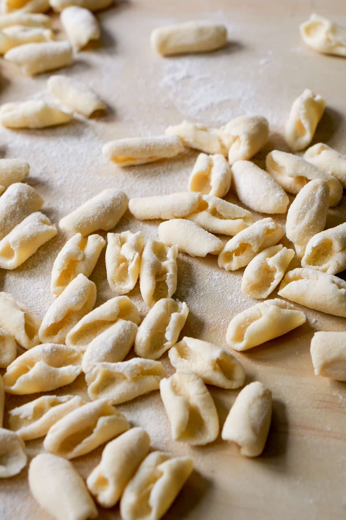 Cavatelli pasta on a wooden board dusted with flour
