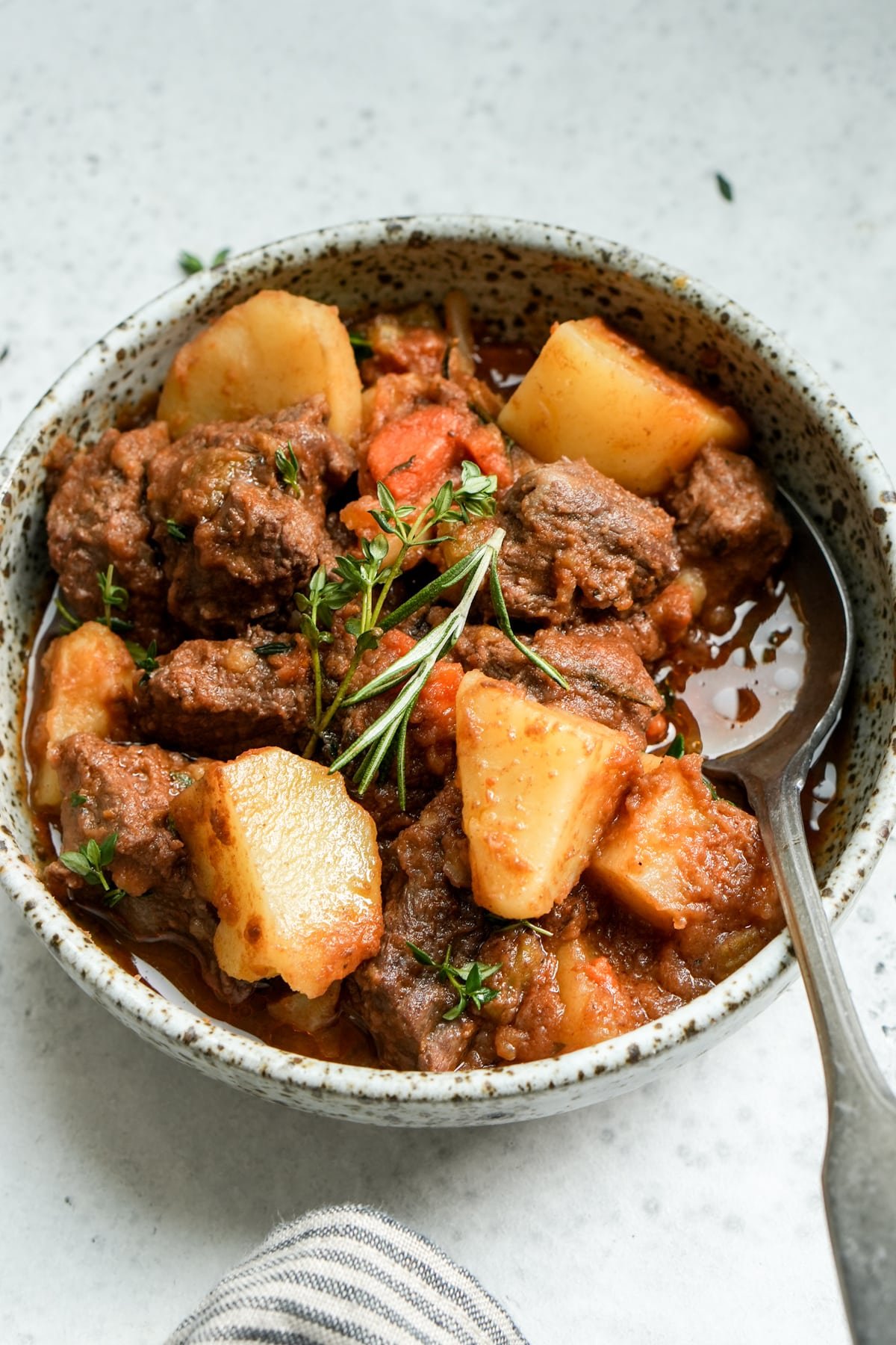 Italian beed stew (spezzatino) in a bowl with a spoon