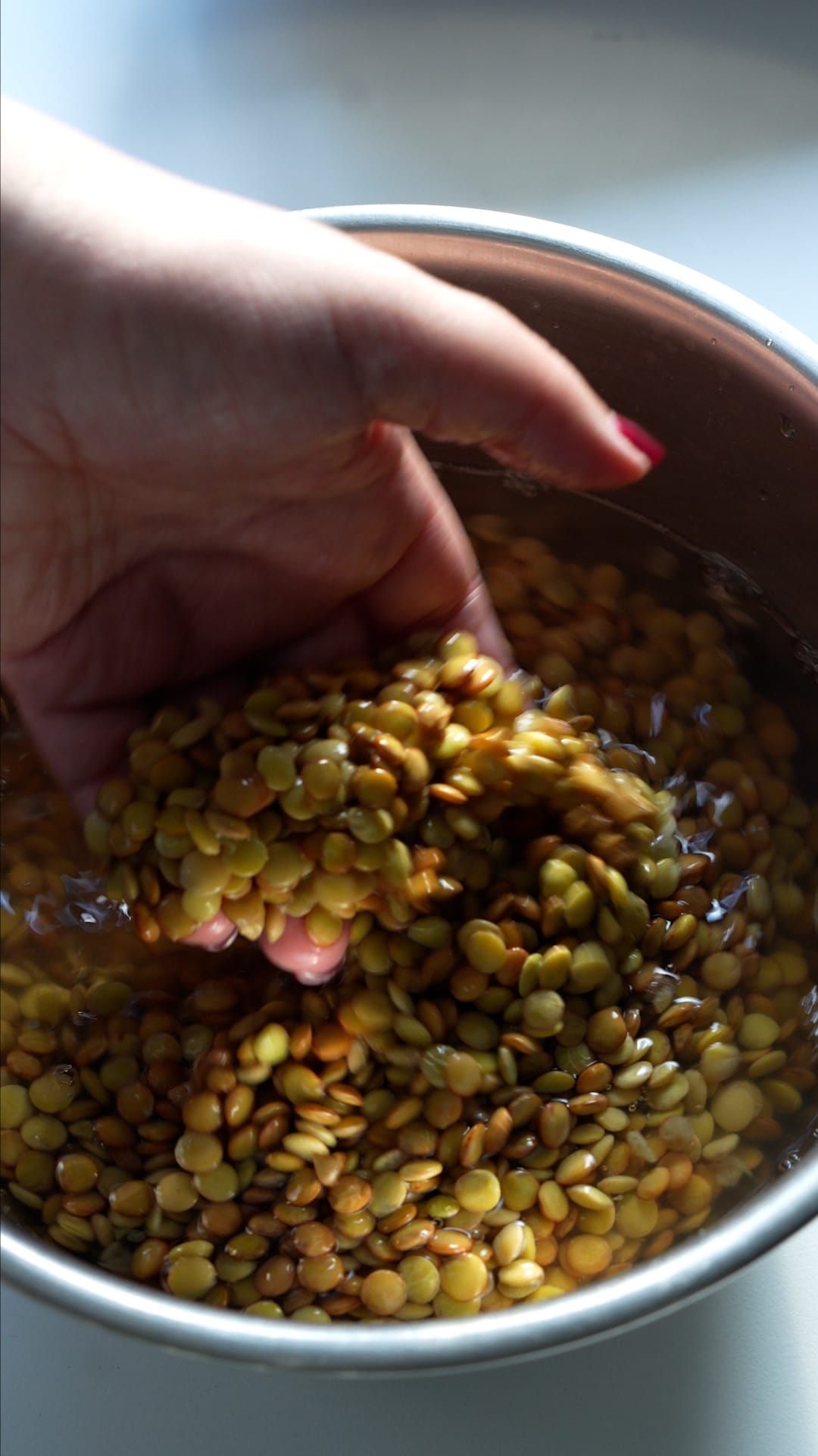 Dry lentils in a bowl with water