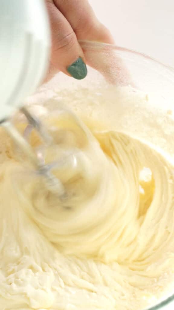 Whisking together eggs, sugar and flour with electric mixer