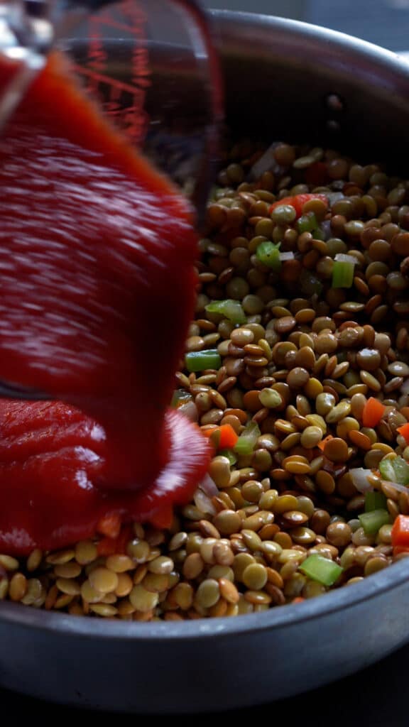 Lentils in pan with passata poured on top