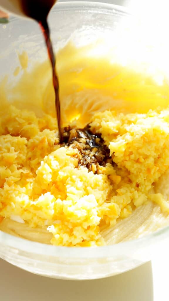 Adding pureed orange, yogurt and vanilla extract to cake batter for orange upside down cake