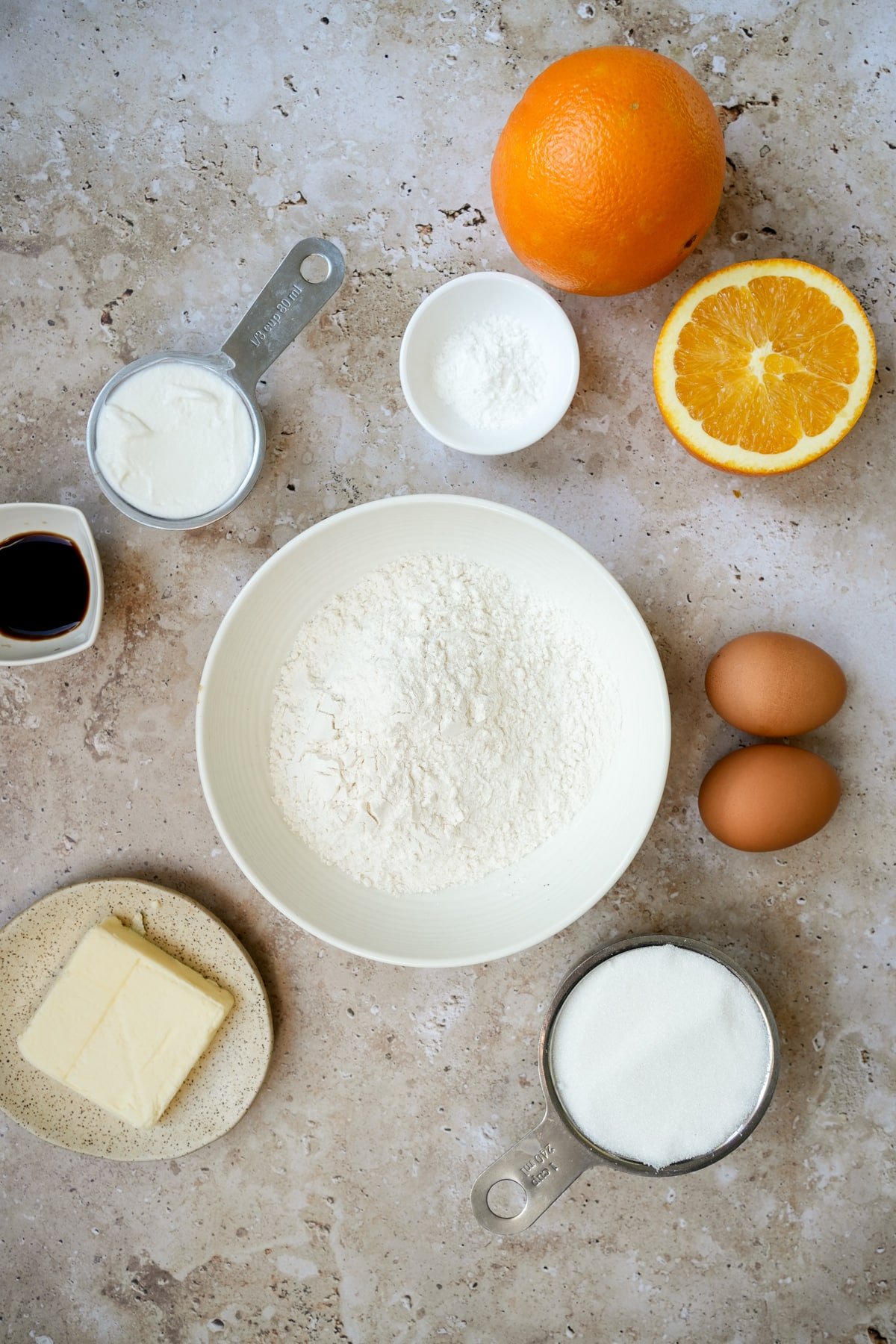 Orange upside down cake ingredients - flour, baking powder, oranges, yogurt, vanilla extract, butter, sugar, eggs