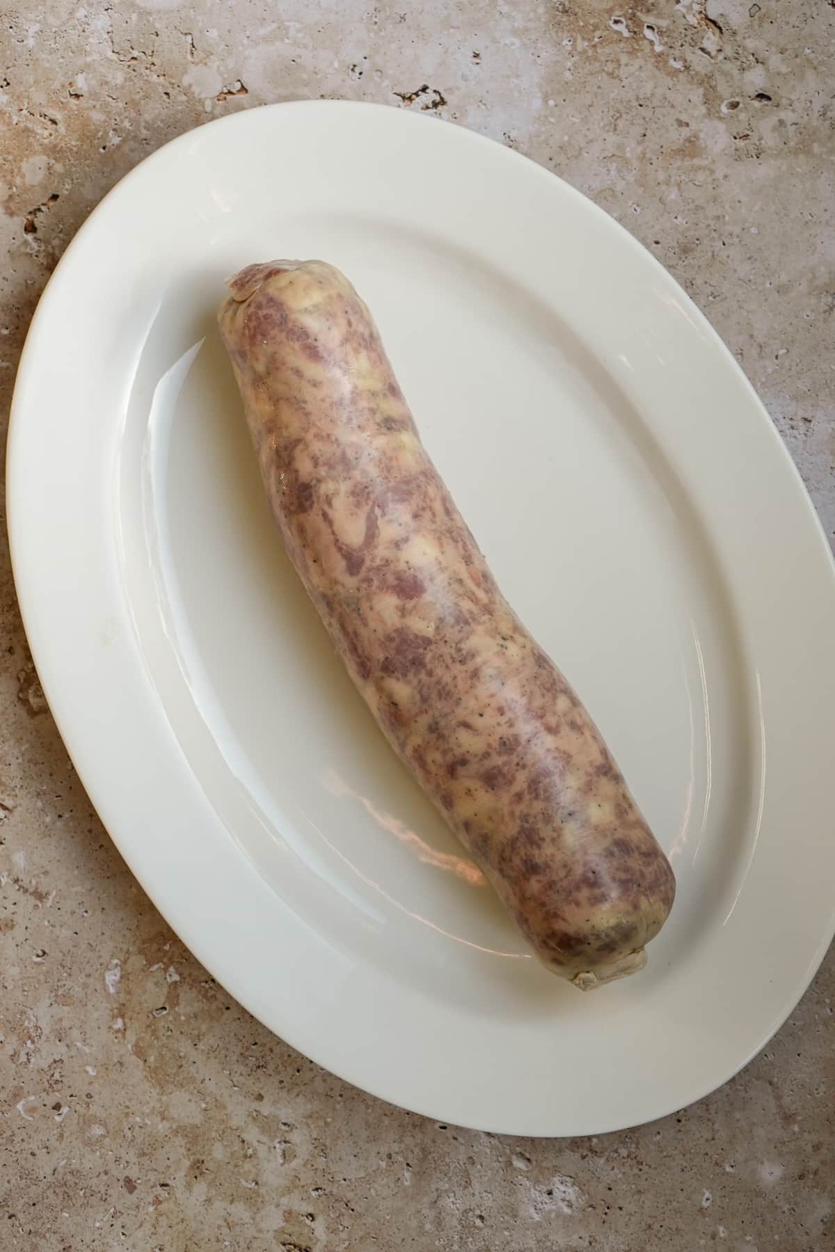 Full cotechino sausage on an oval platter