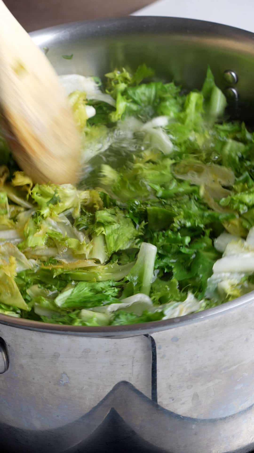 Endive being boiled in a pot