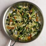 Escarole with raisins and pine nuts in a pan