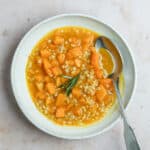 Vegan barley soup in a bowl with a spoon