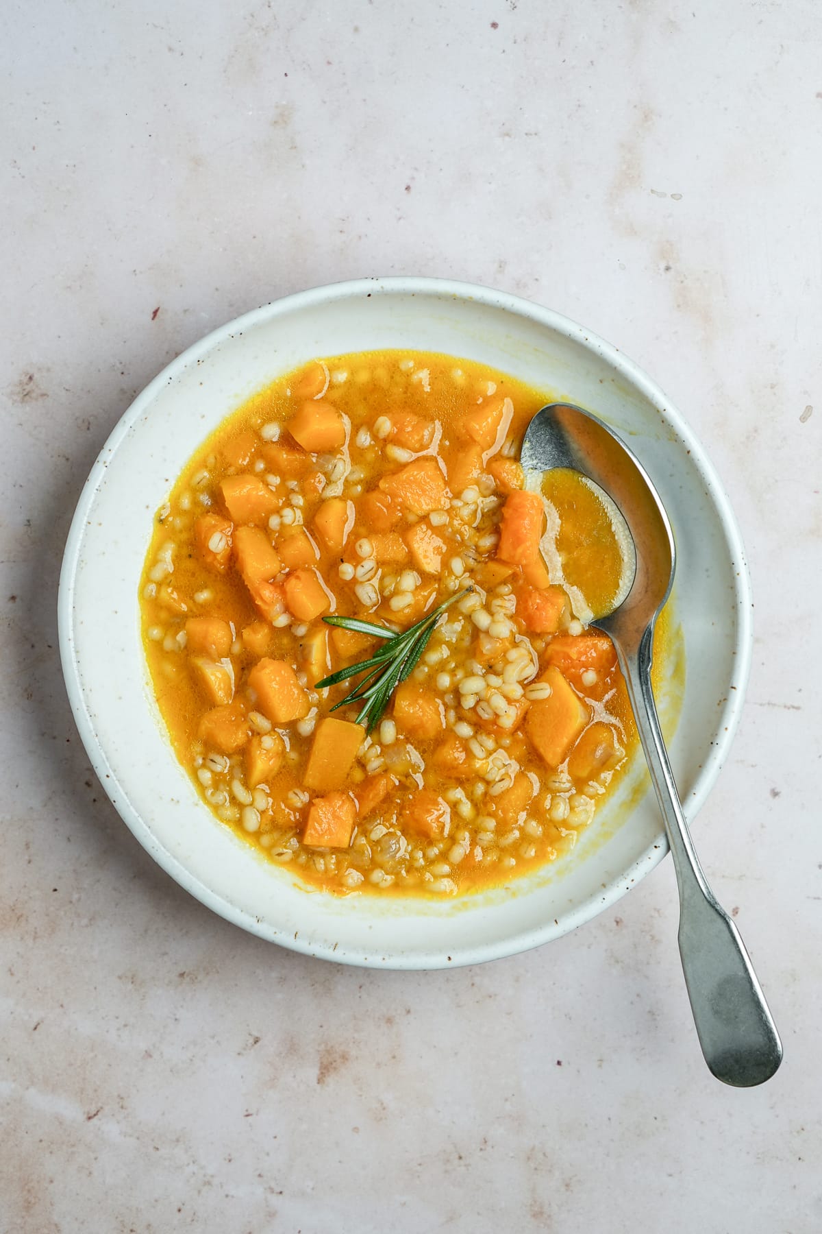 Vegan barley soup in a bowl with a spoon