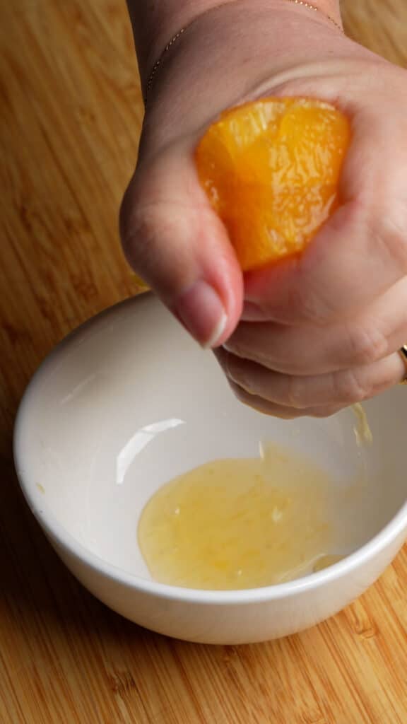 How to make Italian fennel salad (step 1) - make the dressing - squeeze orange juice into a bowl