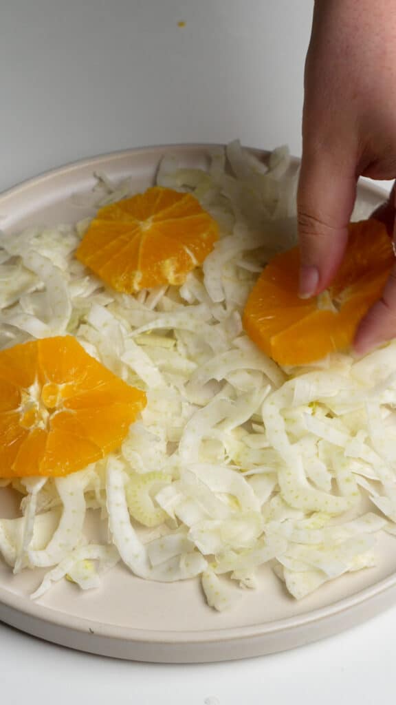 How to make Italian fennel salad (step 6) - assemble the salad - lay down the fennel on a plate