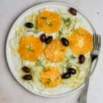 Italian fennel salad topped with ornge rounds nd olives