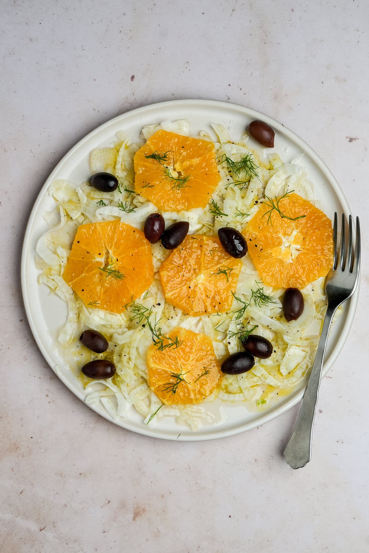 Italian fennel salad topped with ornge rounds nd olives