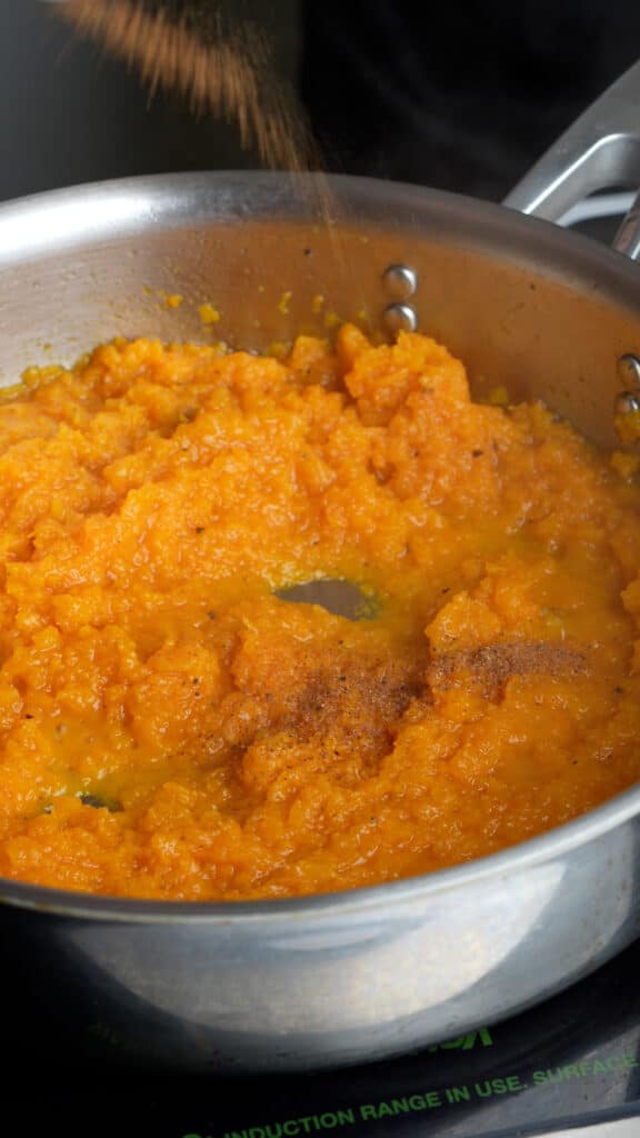 Step by step process on how to make butternut squash-stuffed shells (step 4 - mash the butternut squash)