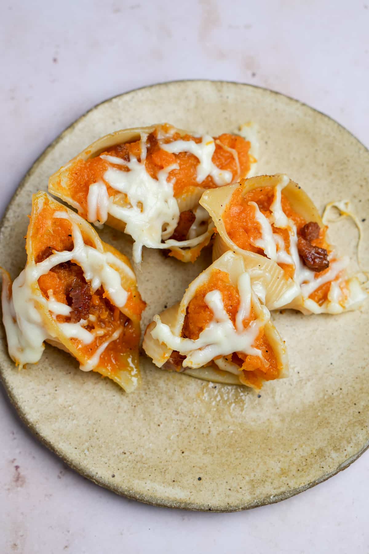 Four butternut squash stuffed shells in a plate