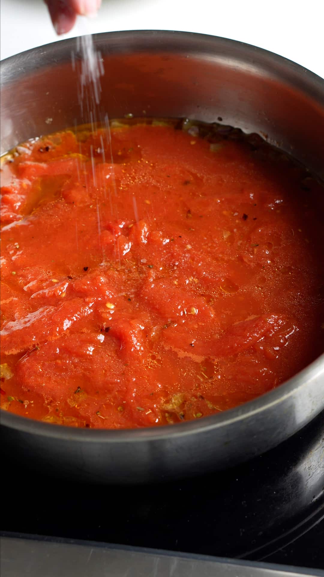 Step by step process on how to make vesuviana pasta - cooked tomato sauce in a pan