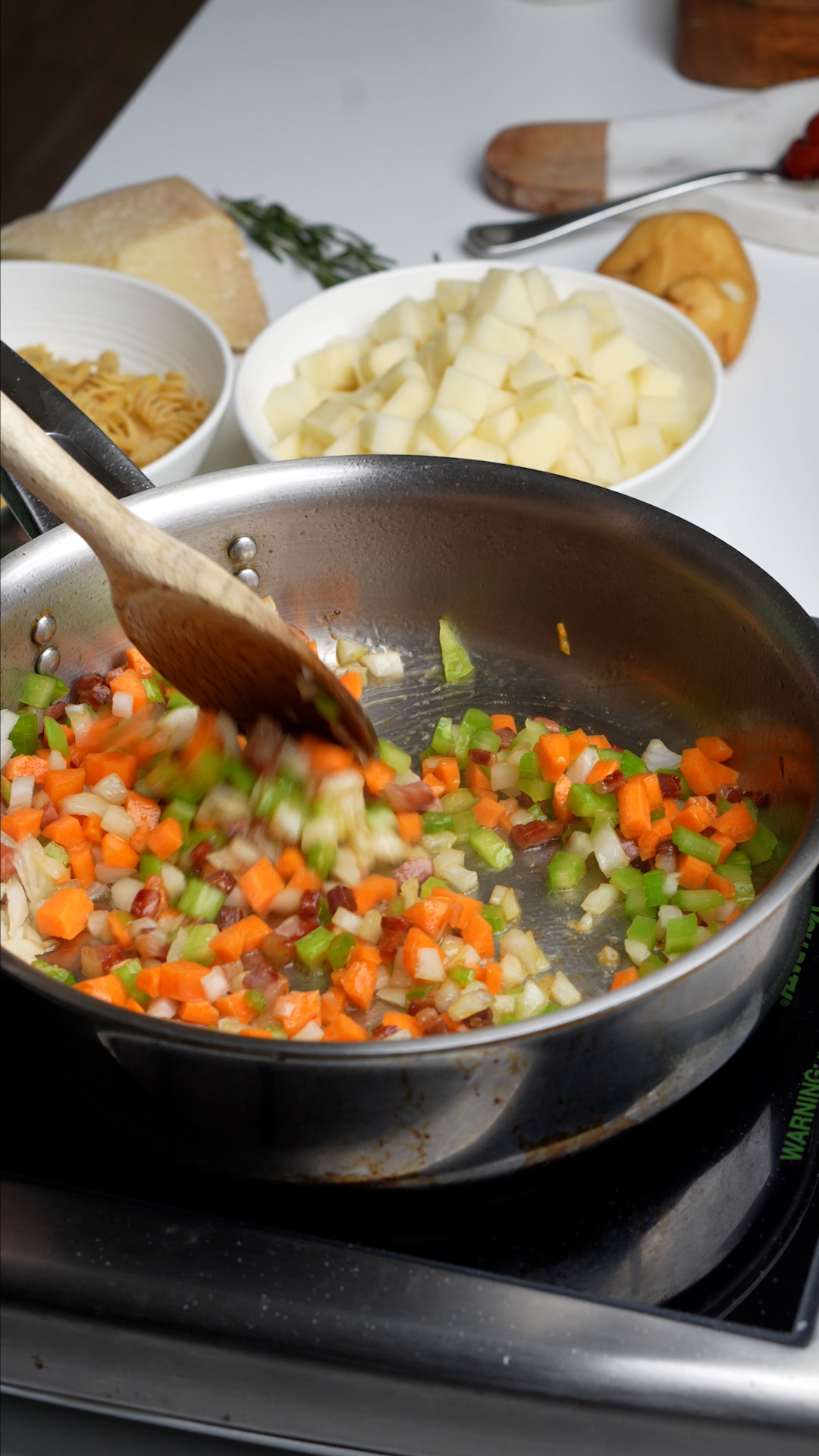 Pancetta, onion, celery and carrot sauteeing in pan