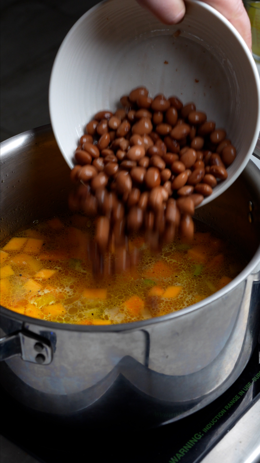 Step by step photos on how to make vegetarian soup with rice - beans added to the pot