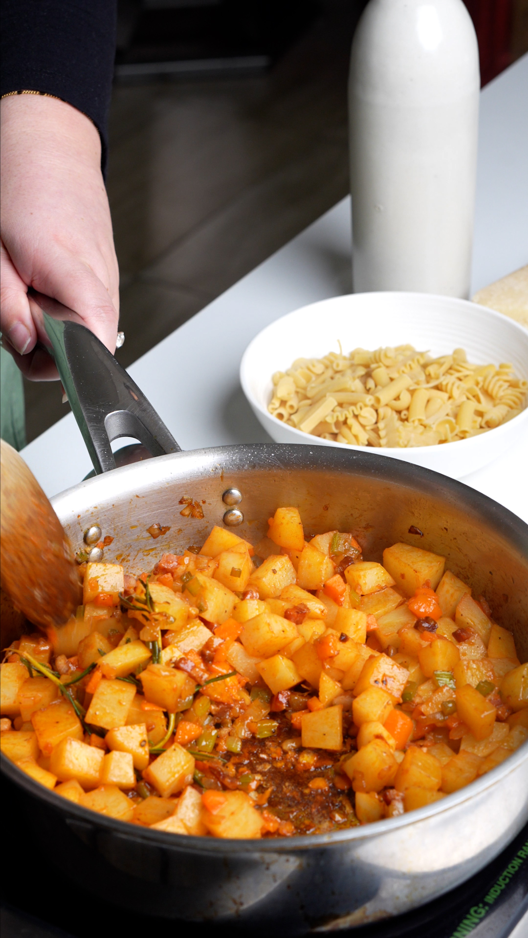 Potatoes, pancetta, celery, carrot and onion cooking in pan