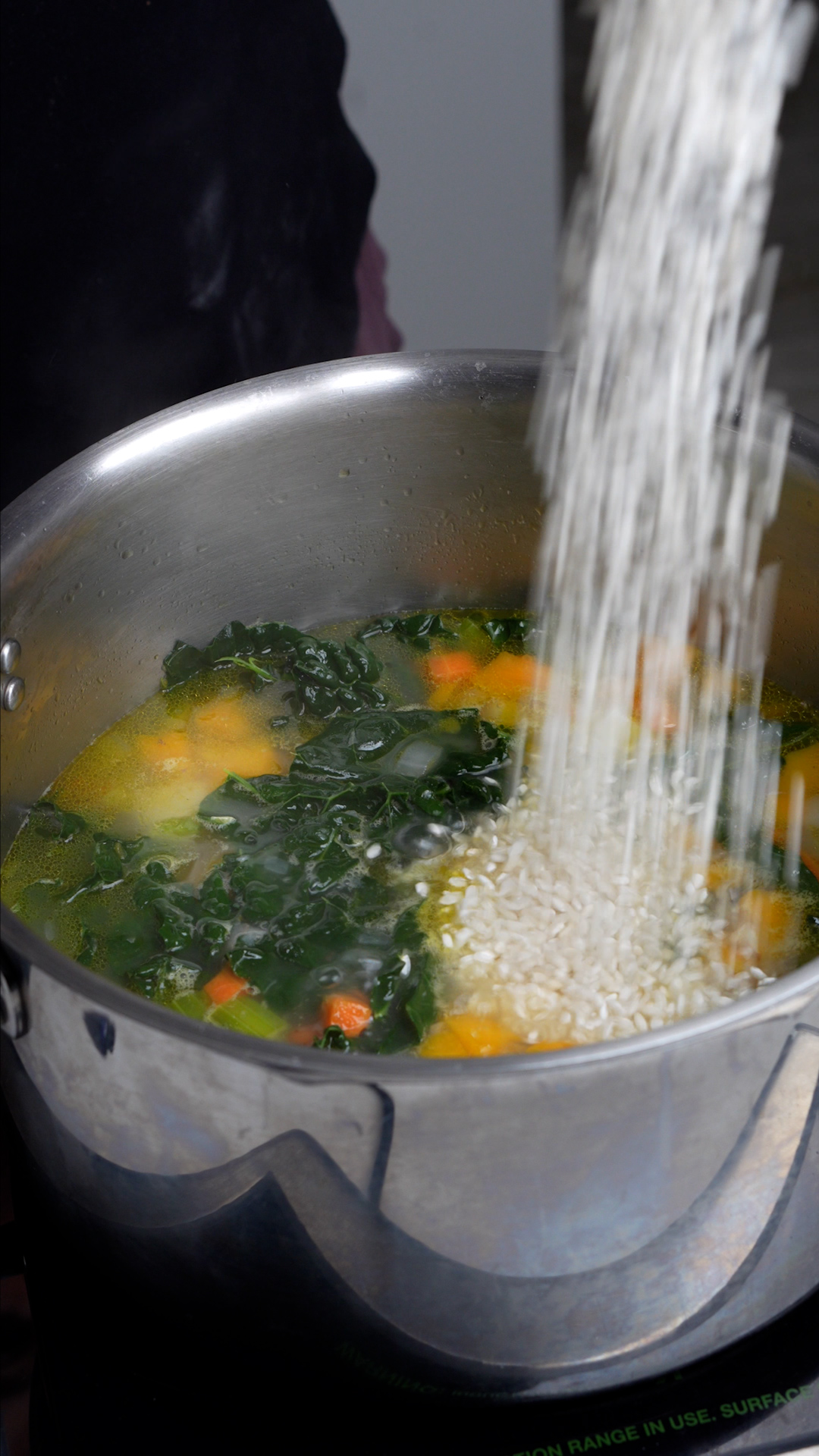 Step by step photos on how to make vegetarian soup with rice - arborio rice added to the pot