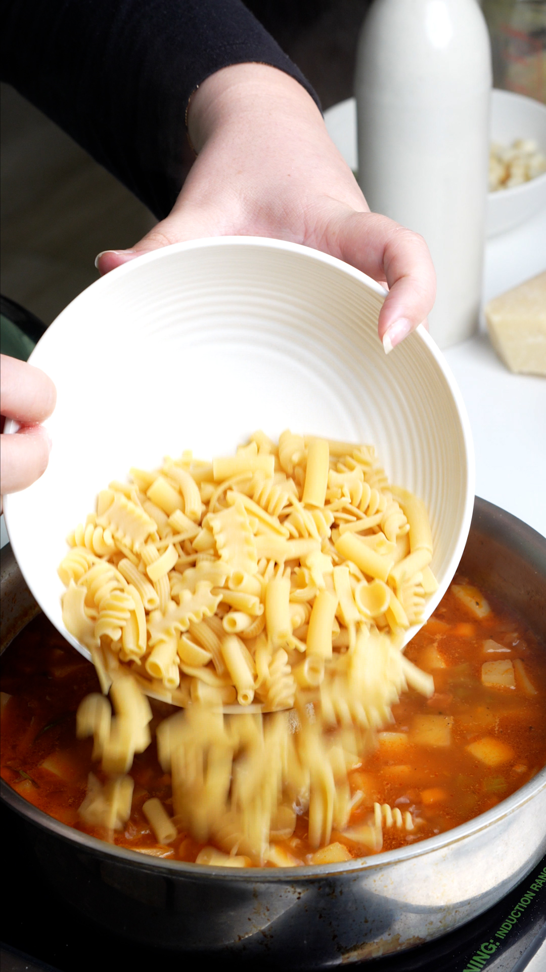 Pasta being added to pan