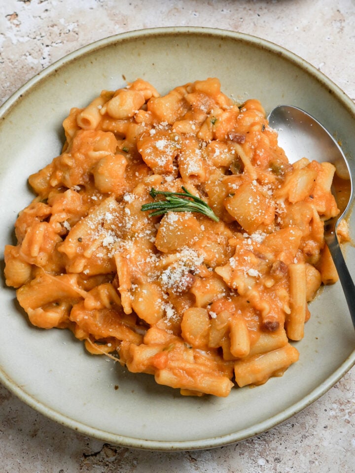Italian pasta and potatoes in a bowl with a spoon